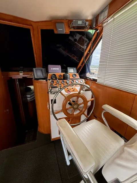 Slide: The Image of Boat cockpit with wooden steering wheel, navigation instruments, and captain's chair. - 12