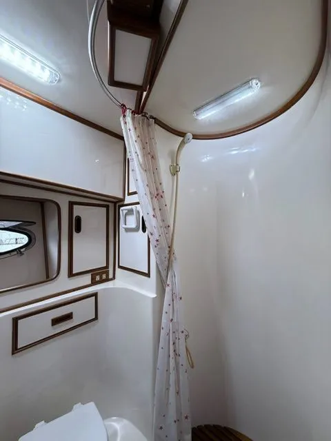 Slide: The Image of Compact bathroom with shower curtain in 1988 President Sedan. - 14