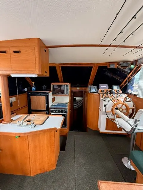 Slide: The Image of Interior of a 1988 President Sedan boat with wooden cabinetry and navigation equipment. - 4