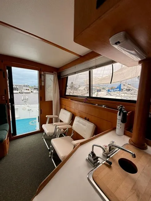 Slide: The Image of Interior of a boat with seating, sink, and marina view through large windows. - 8