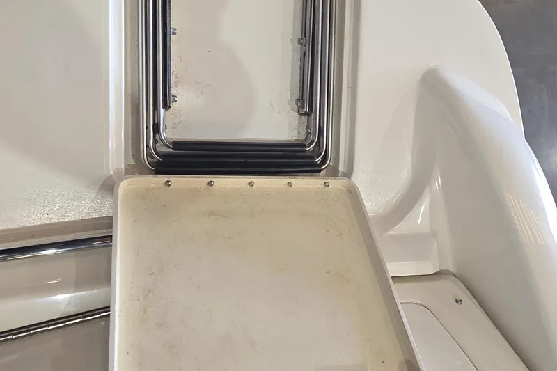 Slide: The Image of 1998 Sea Ray 280 Sun Sport boat interior detail, featuring a hatch and seating area. - 10