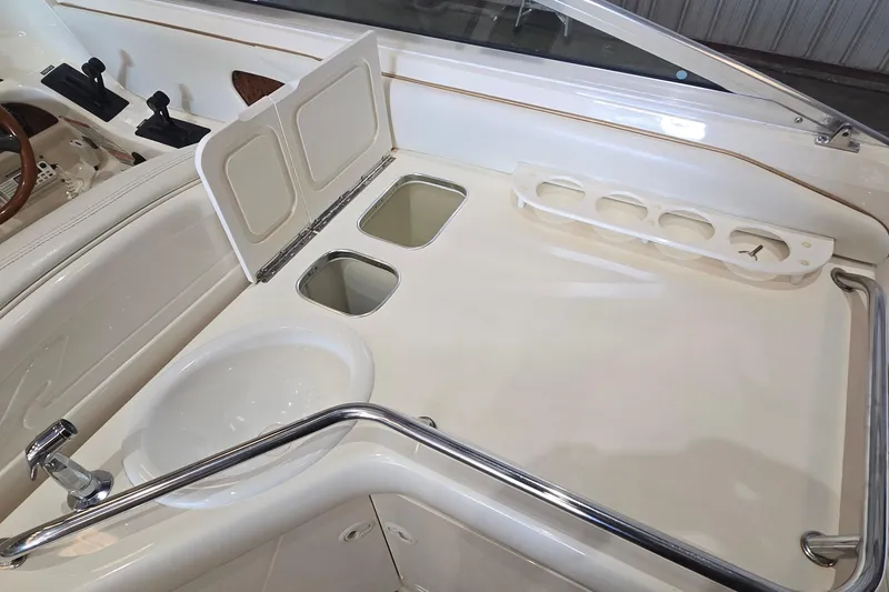 Slide: The Image of 1998 Sea Ray 280 Sun Sport boat interior with sink and storage compartments. - 14