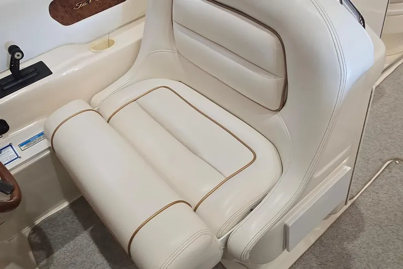 Slide: The Image of 1998 Sea Ray 280 Sun Sport boat seat with white upholstery and brown accents. - 16
