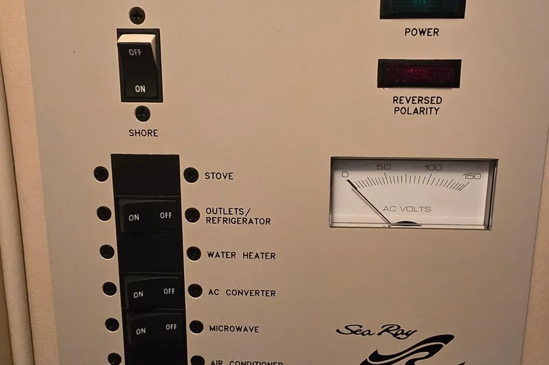 Slide: The Image of Electrical panel of 1998 Sea Ray 280 Sun Sport boat with AC voltage meter. - 26