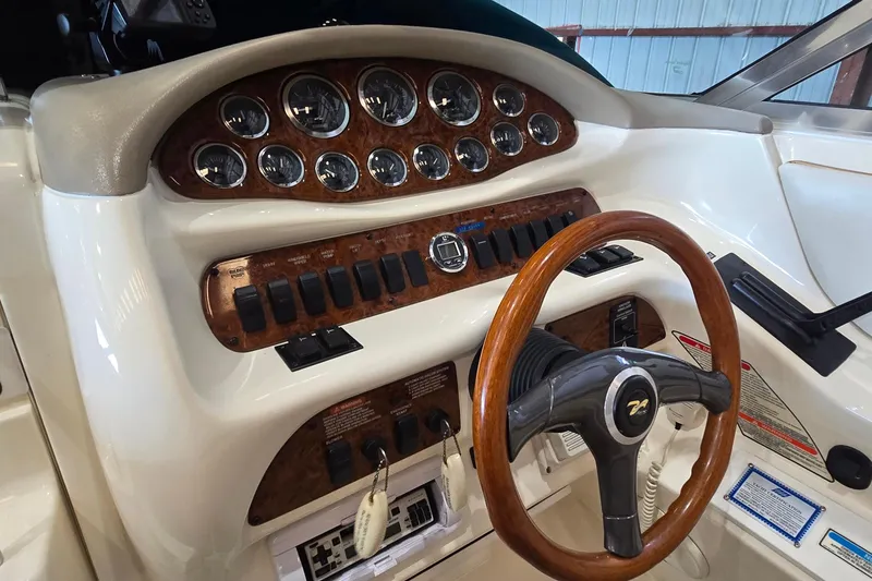 Slide: The Image of 1998 Sea Ray 280 Sun Sport dashboard with wood accents and steering wheel. - 32