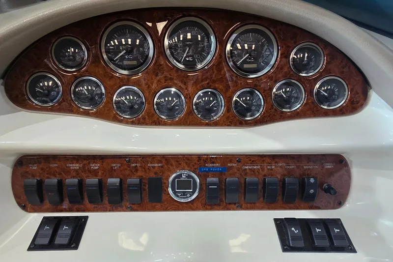 Slide: The Image of 1998 Sea Ray 280 Sun Sport dashboard with gauges and control switches. - 35