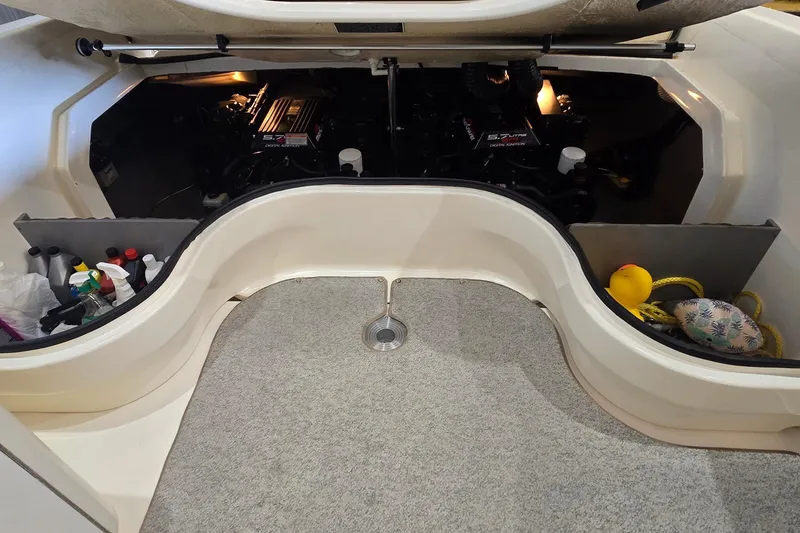 Slide: The Image of Engine compartment of a 1998 Sea Ray 280 Sun Sport boat, showing storage and maintenance items. - 46