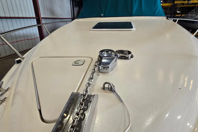 Slide: The Image of 1998 Sea Ray 280 Sun Sport boat deck with anchor chain and hatch. - 7