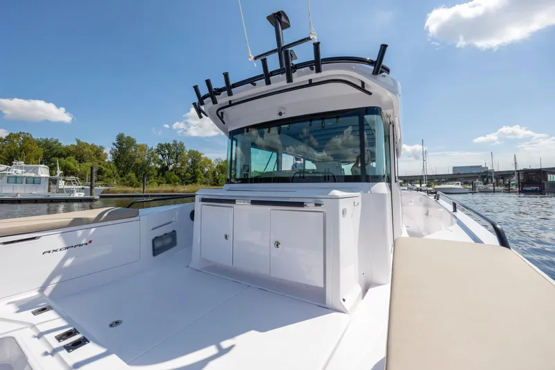 Slide: The Image of 2024 Axopar 37 XC boat on water, showcasing sleek design and spacious deck. - 43
