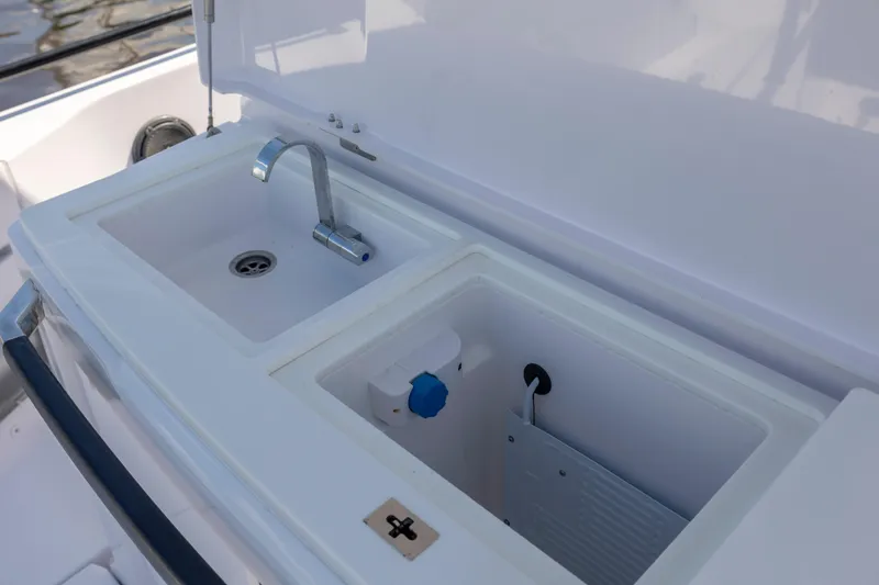 Slide: The Image of 2024 Axopar 37 XC boat sink and storage compartment detail. - 45