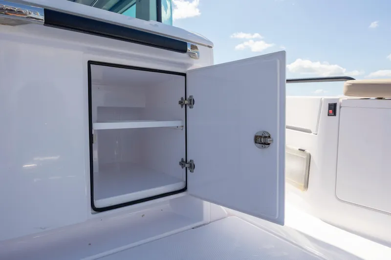 Slide: The Image of Open storage compartment on 2024 Axopar 37 XC boat, showcasing interior shelving. - 46