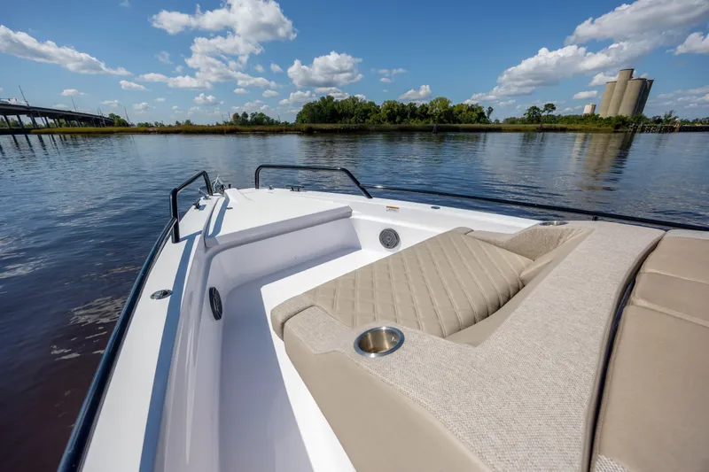 Slide: The Image of 2024 Axopar 37 XC boat on calm water, featuring luxurious seating and clear blue skies. - 50