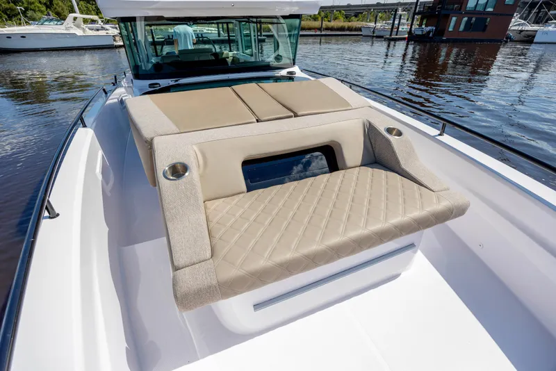 Slide: The Image of 2024 Axopar 37 XC boat with luxurious seating and sleek design on the water. - 52