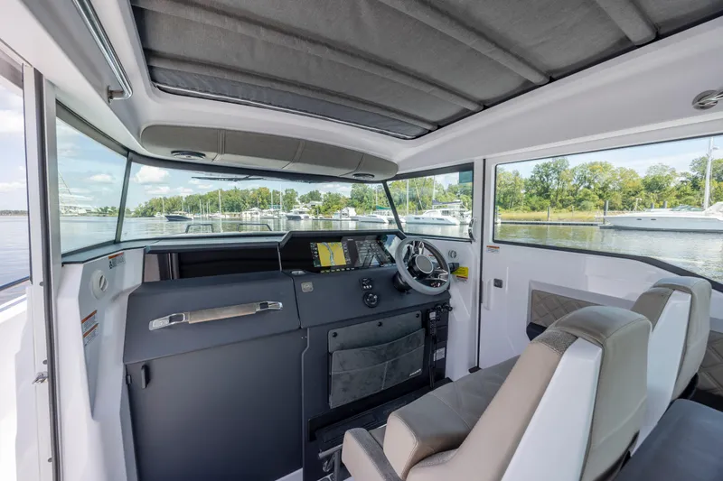 Slide: The Image of 2024 Axopar 37 XC boat interior with modern dashboard and comfortable seating. - 55