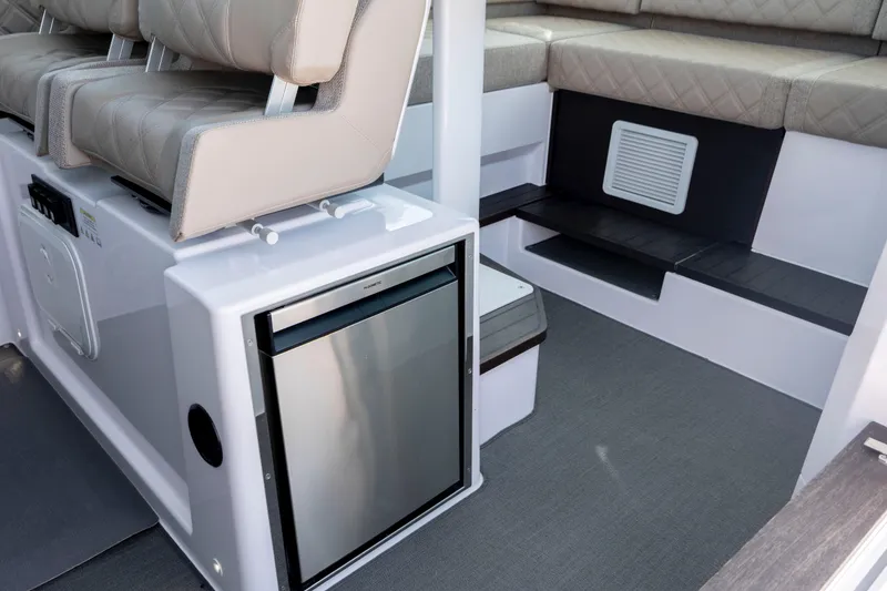Slide: The Image of 2024 Axopar 37 XC interior with seating and compact refrigerator. - 58