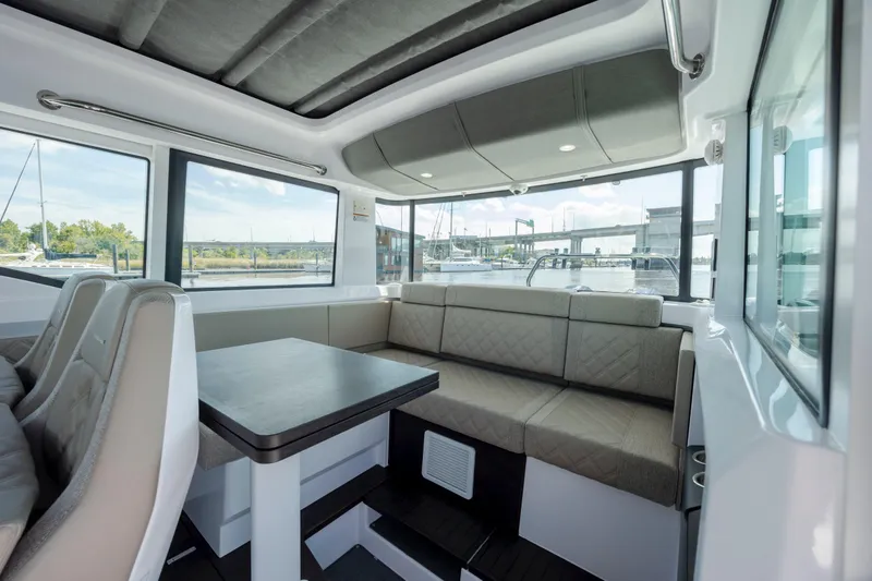 Slide: The Image of Luxurious interior of 2024 Axopar 37 XC boat with spacious seating and panoramic windows. - 59