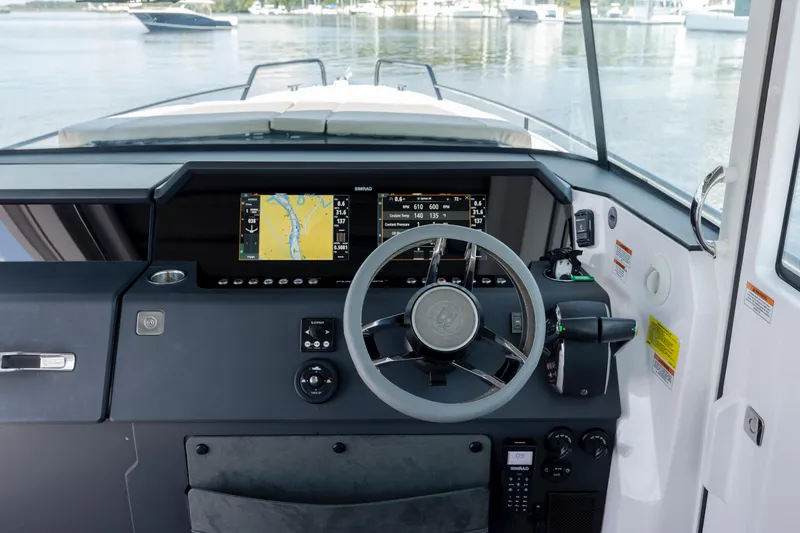 Slide: The Image of 2024 Axopar 37 XC helm with navigation display and steering wheel. - 60