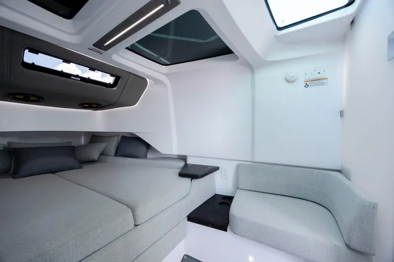 Slide: The Image of 2024 Axopar 37 XC cabin interior with modern seating and skylights. - 65