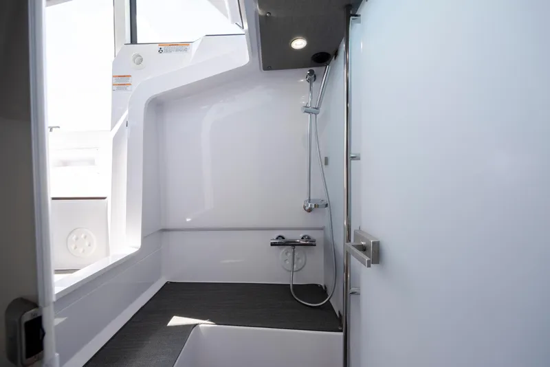 Slide: The Image of 2024 Axopar 37 XC boat interior shower with modern fixtures and sleek design. - 67