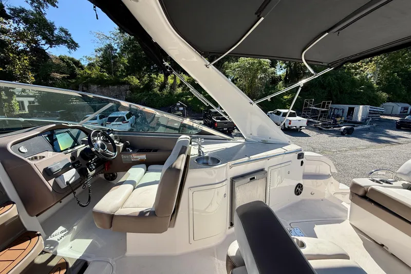 Slide: The Image of 2017 Regal 32 Express yacht interior with kitchenette and sink, docked by the water. - 12