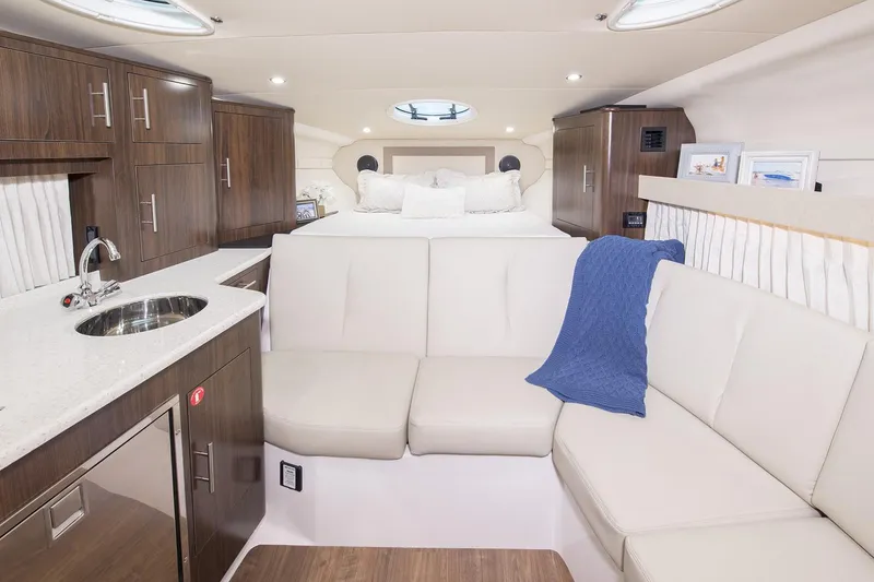 Slide: The Image of Luxurious interior of a 2017 Regal 32 Express yacht with sofa, bed, and TV. - 19