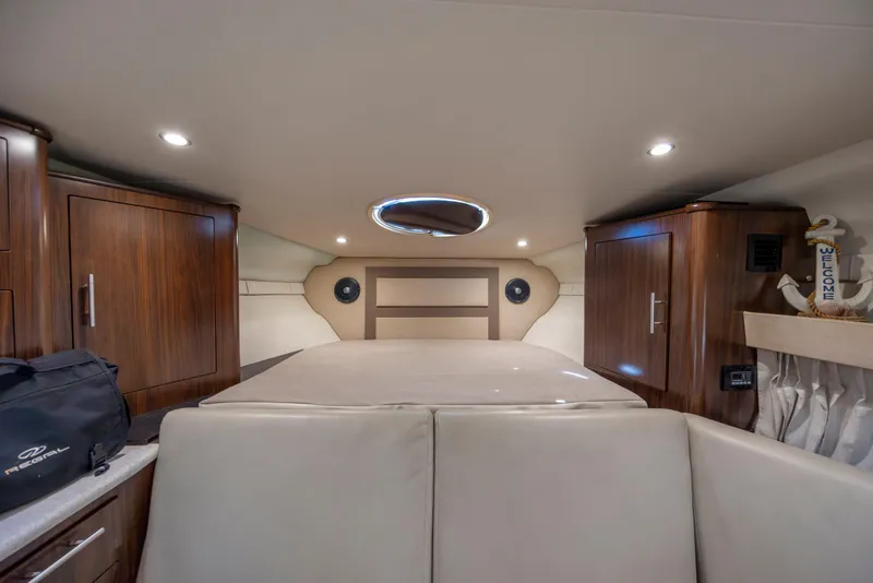 Slide: The Image of Interior cabin of 2017 Regal 32 Express boat with wood cabinets and cozy seating. - 26