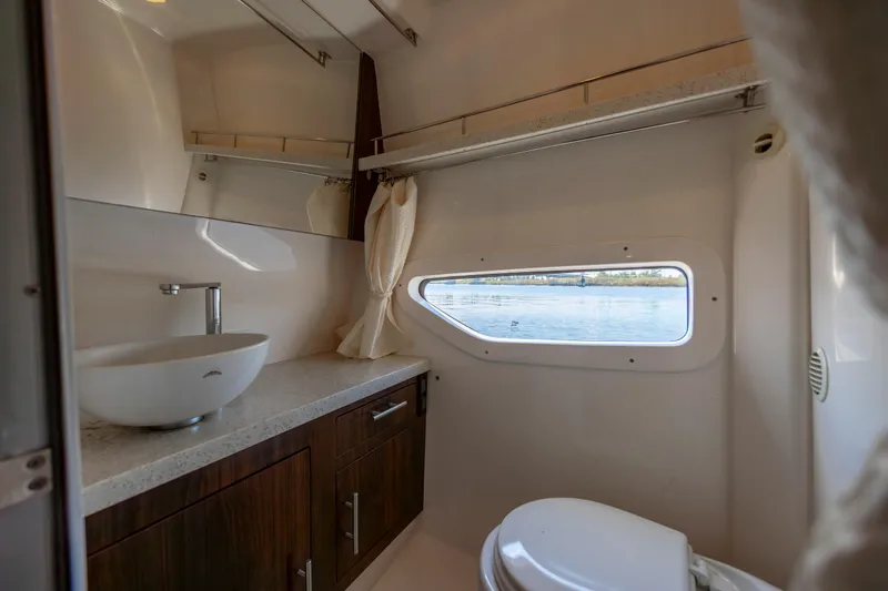 Slide: The Image of Luxurious bathroom interior of 2017 Regal 32 Express yacht with window view. - 27