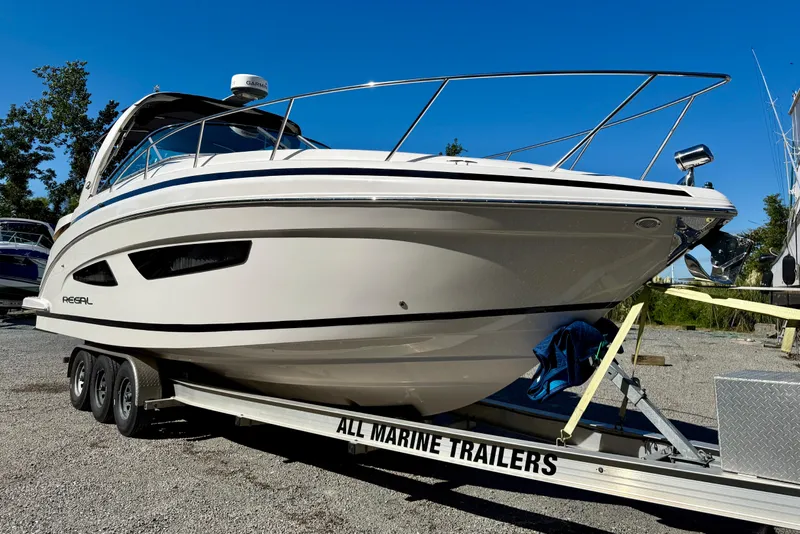 Slide: The Image of 2017 Regal 32 Express boat cruising on calm water under a clear sky. - 3