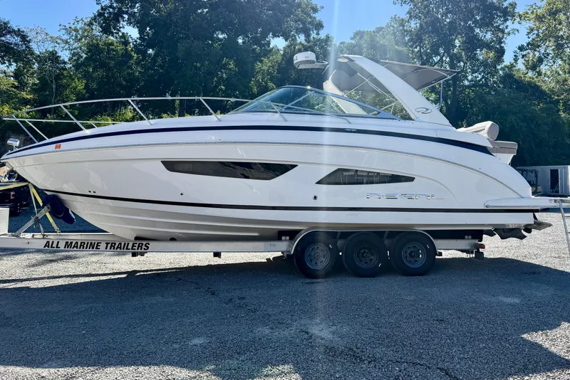 Slide: The Image of 2017 Regal 32 Express boat cruising on a calm waterway. - 5