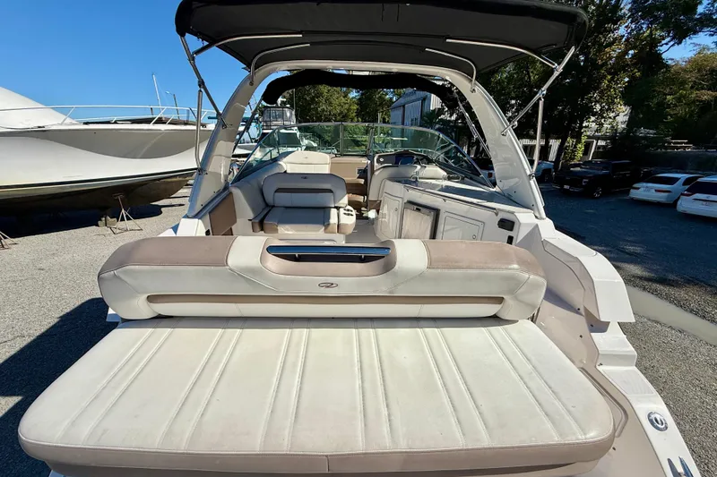 Slide: The Image of 2017 Regal 32 Express boat cruising on a calm river with bridge in background. - 6