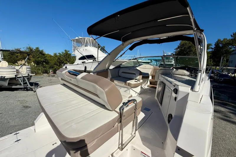 Slide: The Image of 2017 Regal 32 Express boat interior with seating, canopy, and water view. - 7