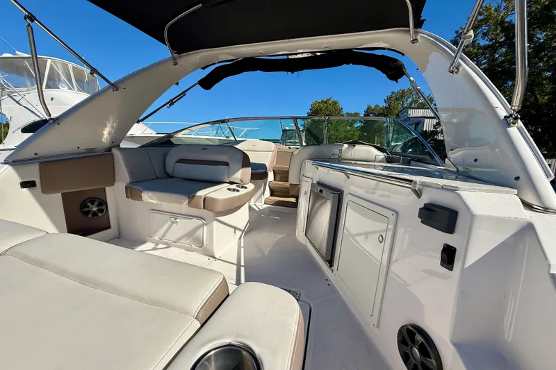 Slide: The Image of 2017 Regal 32 Express boat interior with canopy, docked on a sunny day. - 8
