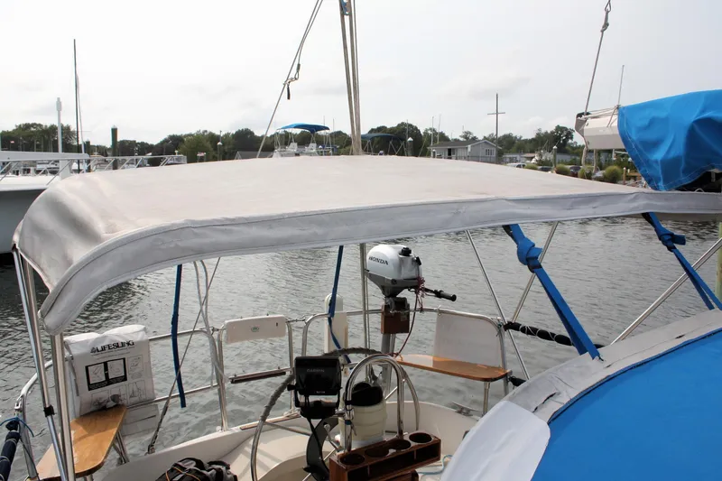 Slide: The Image of 1988 Pearson 31 sailboat cockpit with canopy, docked in a marina. - 17