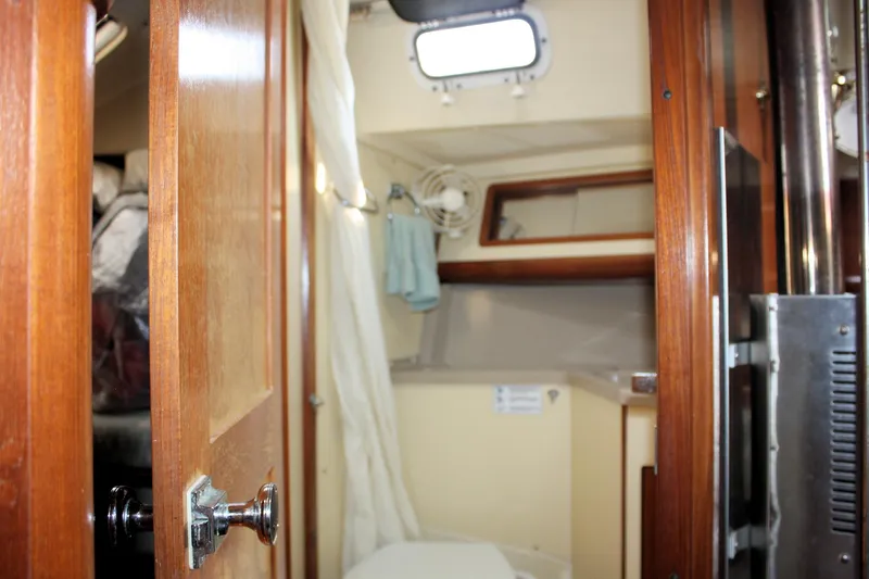 Slide: The Image of Interior of 1988 Pearson 31 sailboat with wooden doors and compact cabin space. - 29