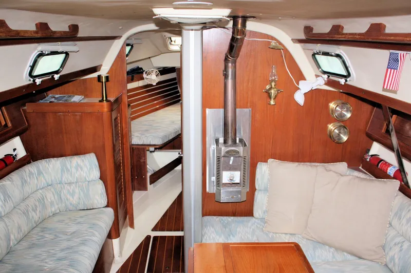 Slide: The Image of Interior of a 1988 Pearson 31 sailboat with cozy seating and wood accents. - 30