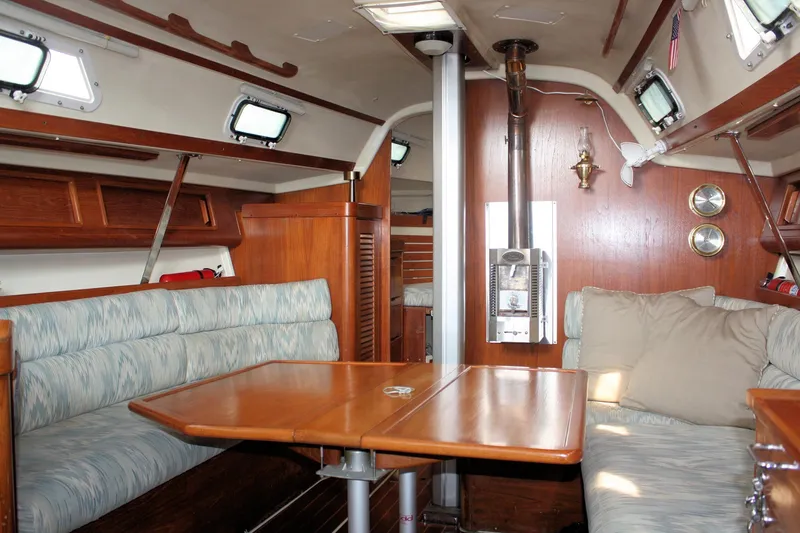Slide: The Image of Interior of a 1988 Pearson 31 sailboat with cozy seating and wooden finishes. - 37