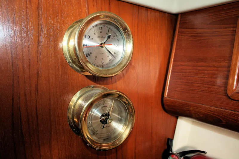 Slide: The Image of Brass clock and barometer on 1988 Pearson 31 yacht's wooden interior. - 41