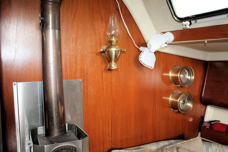 Slide: The Image of Interior of a 1988 Pearson 31 sailboat with wood paneling and brass fixtures. - 42