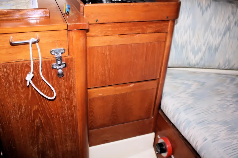 Slide: The Image of Interior of 1988 Pearson 31 sailboat with wooden cabinetry and cushioned seating. - 48