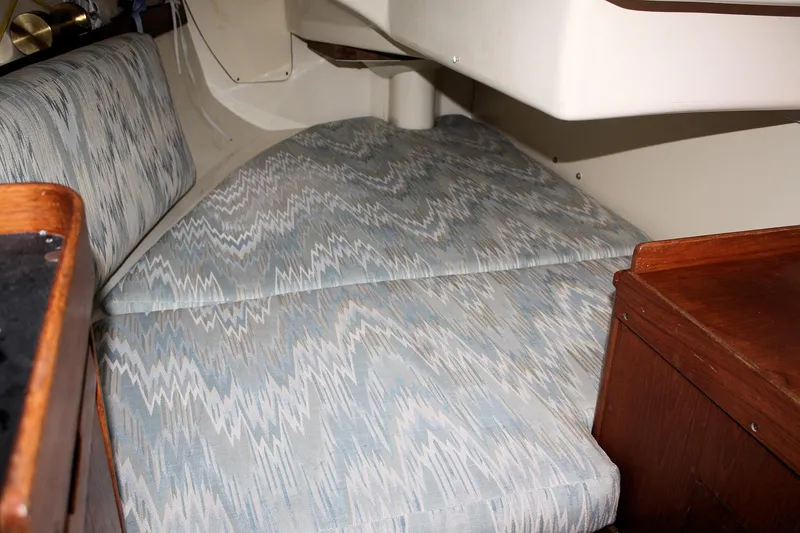 Slide: The Image of Interior cabin of a 1988 Pearson 31 sailboat with patterned cushions. - 49