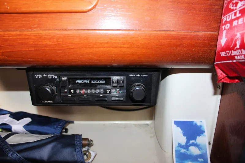 Slide: The Image of 1988 Pearson 31 boat interior with vintage Prospec radio and wooden paneling. - 51