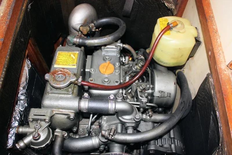 Slide: The Image of 1988 Pearson 31 engine compartment with visible components and hoses. - 53