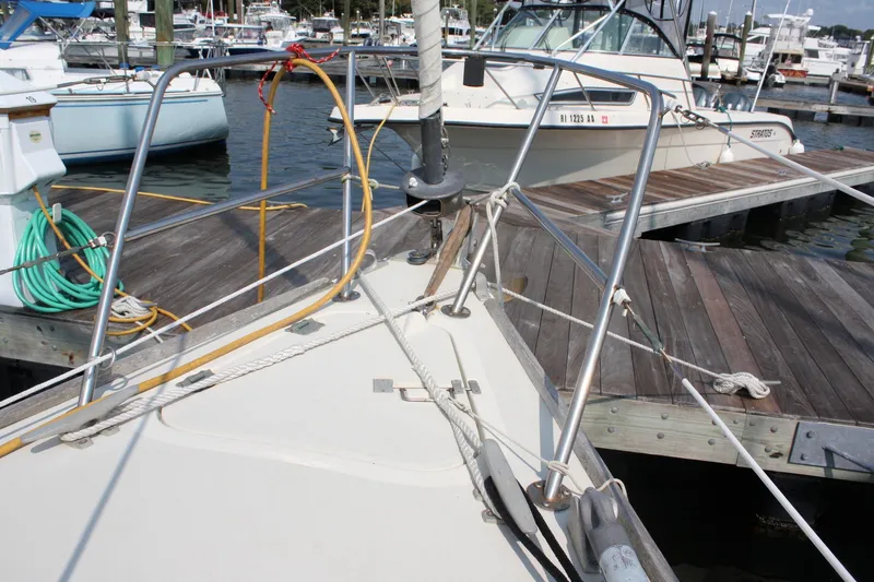 Slide: The Image of Bow of a 1988 Pearson 31 sailboat docked at a marina. - 6