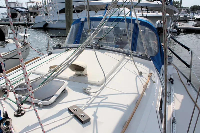 Slide: The Image of 1988 Pearson 31 sailboat docked, featuring deck and rigging details. - 9
