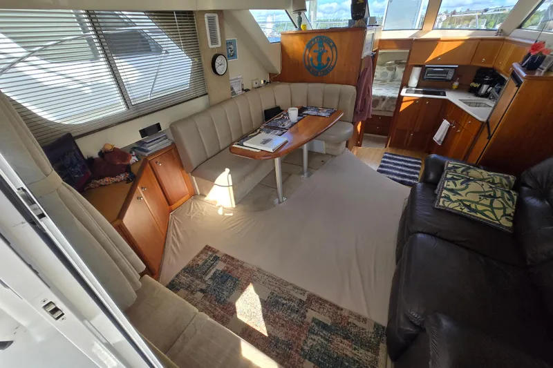 Slide: The Image of Interior of 2002 Silverton 351 Sedan Cruiser with cozy seating and kitchenette. - 1