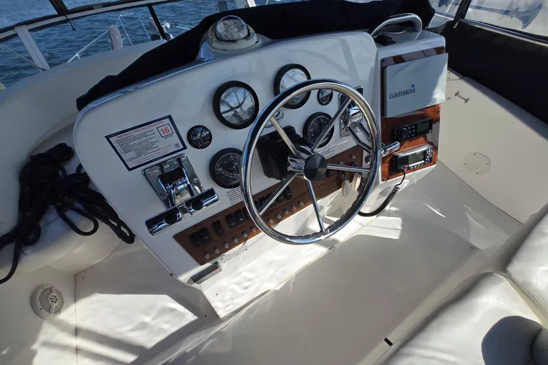 Slide: The Image of 2002 Silverton 351 Sedan Cruiser helm with steering wheel and navigation instruments. - 14