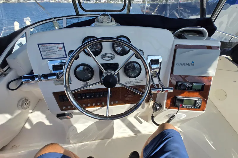 Slide: The Image of 2002 Silverton 351 Sedan Cruiser helm with Garmin navigation and control instruments. - 17