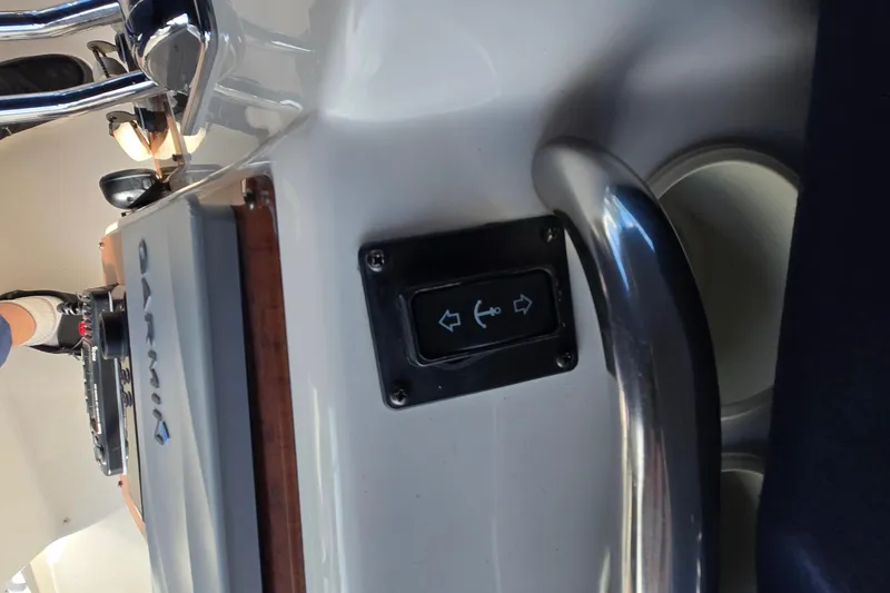 Slide: The Image of 2002 Silverton 351 Sedan Cruiser helm with Garmin equipment and directional control panel. - 19