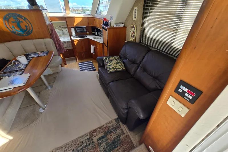 Slide: The Image of Interior of 2002 Silverton 351 Sedan Cruiser with cozy seating and kitchenette. - 24