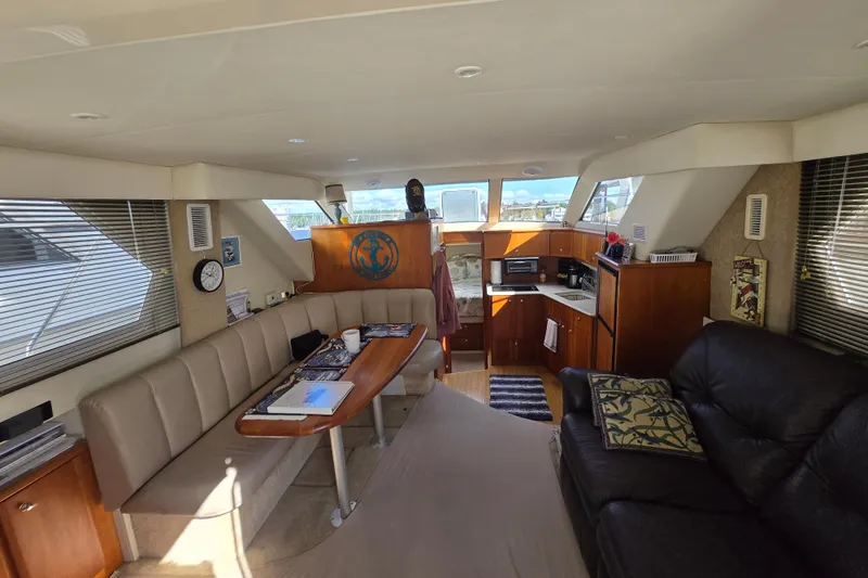 Slide: The Image of Interior of 2002 Silverton 351 Sedan Cruiser with kitchen and seating area. - 25